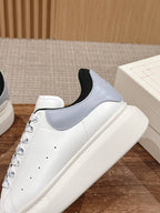 Alexander McQueen white leather sneaker with gray side panel and black collar