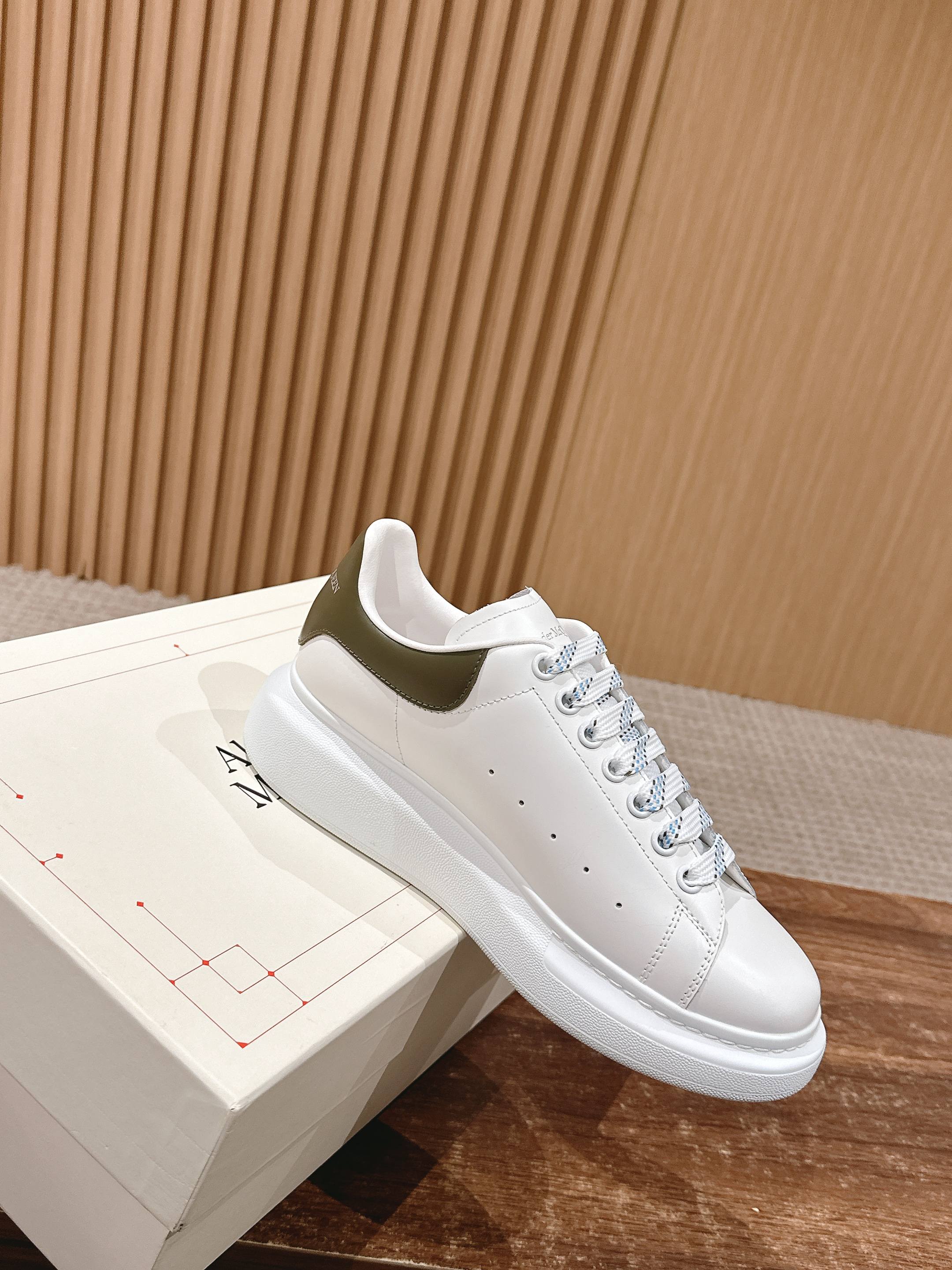 White leather low-top sneakers with lace-up front and grippy sole