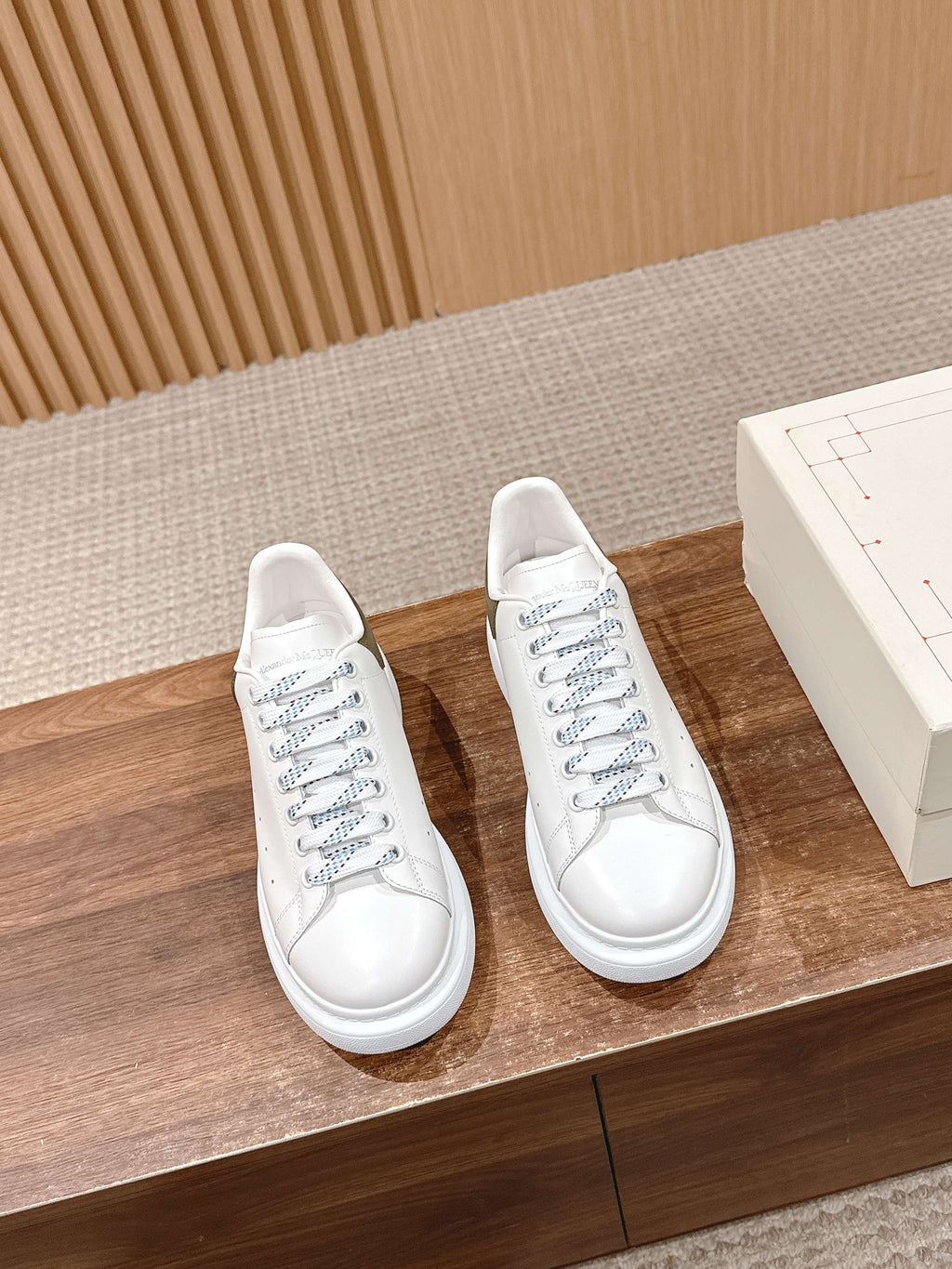 White leather lace-up sneakers pair with white rubber sole