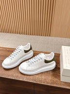White leather low-top sneakers with perforated toe and white rubber sole