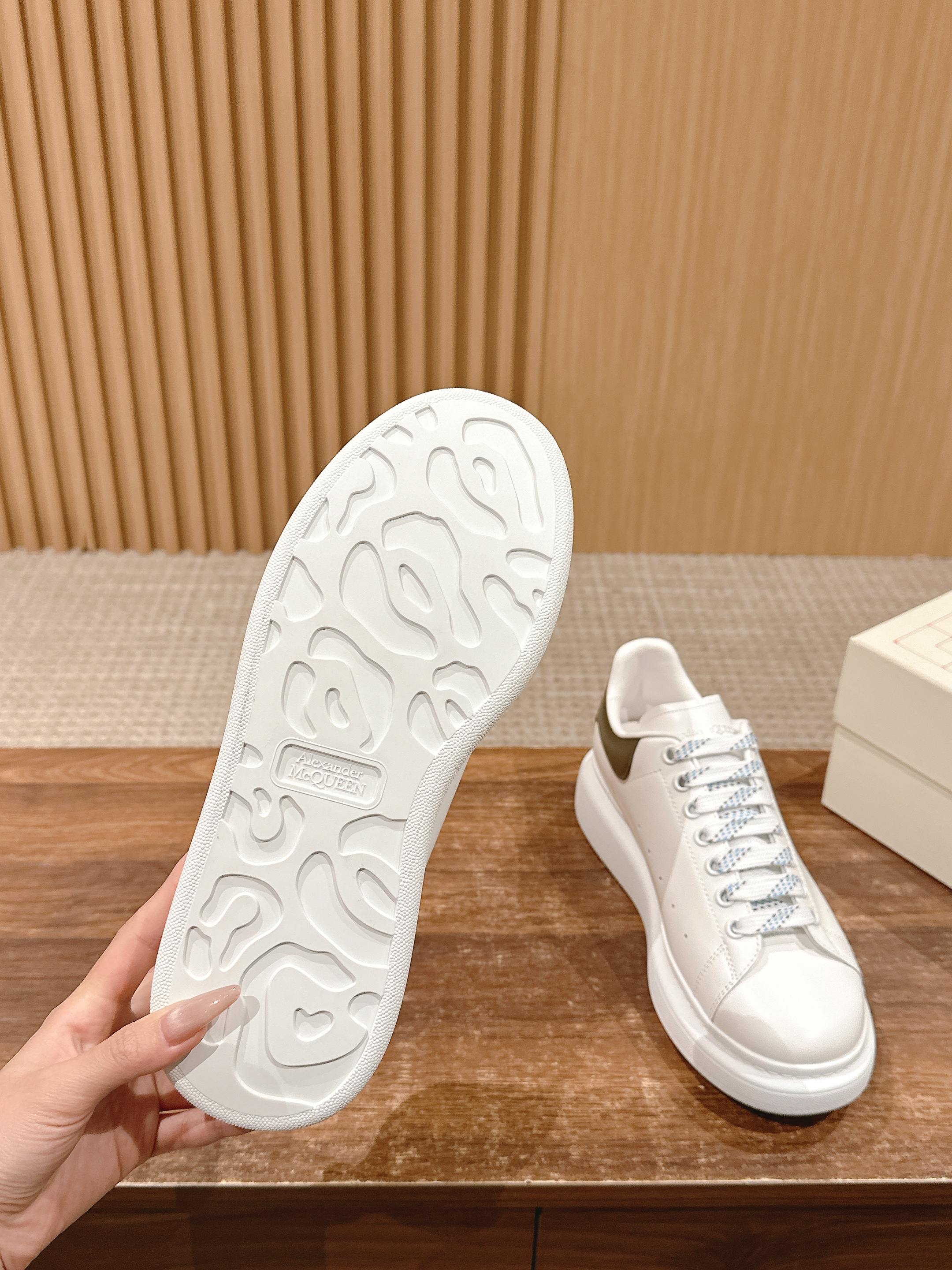 White sneaker sole and side view with tread, blue-laced low-top