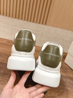 White low-top sneakers with Alexander McQueen logo on heel counter