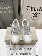 Golden Goose white sneakers with gray laces, perforated toe, on shoebox