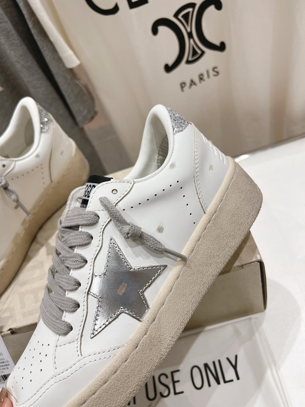 Golden Goose white low-top sneaker with gray laces, star patch, beige sole