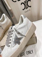 Golden Goose white low-top sneaker with gray laces, star patch, beige sole