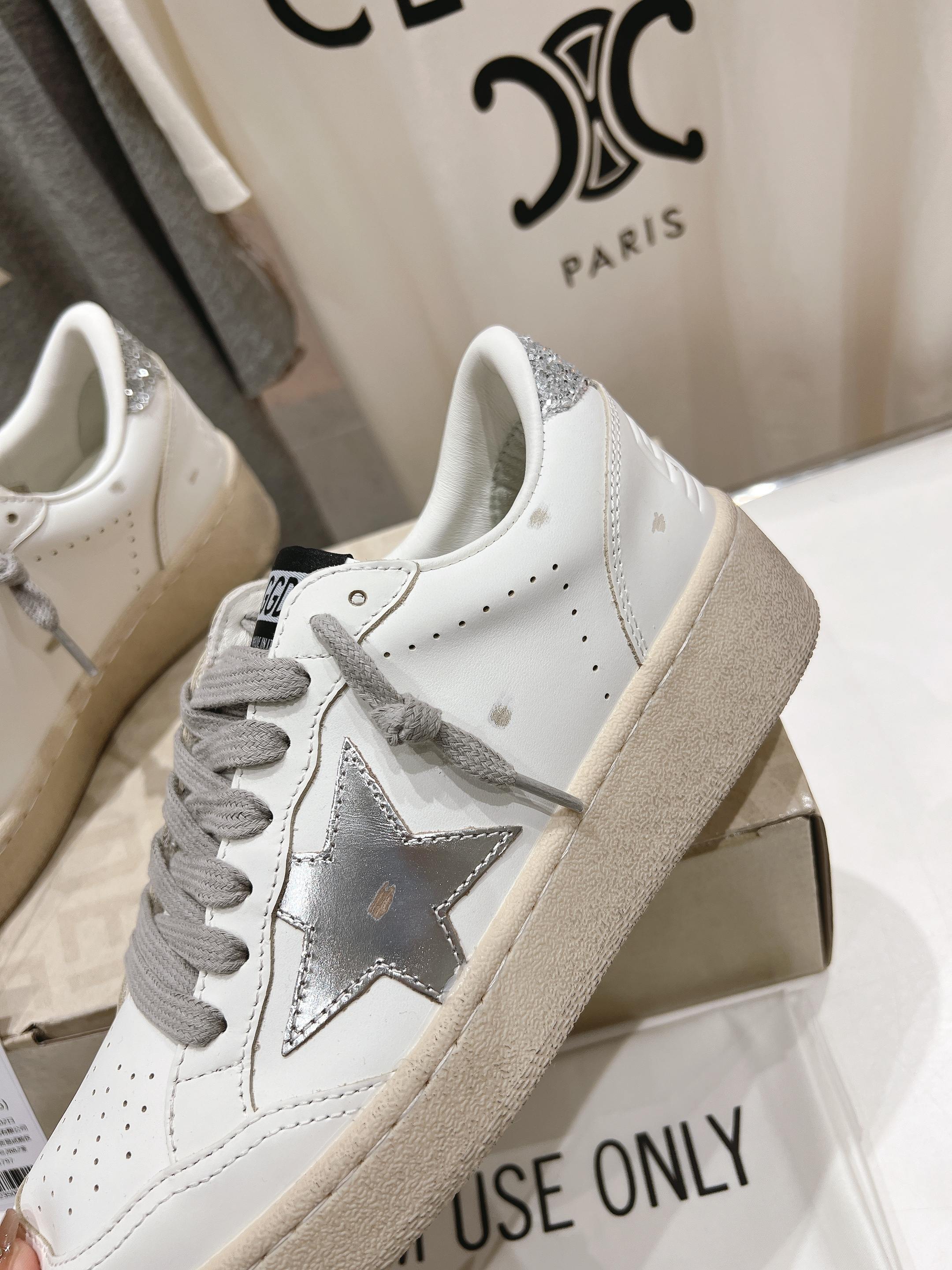 Golden Goose white low-top sneaker with gray laces, star patch, beige sole