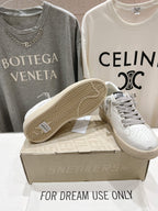 Golden Goose white sneakers with gray laces, open sole showing herringbone tread