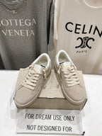 White low-top lace-up sneakers with perforated toe, pair on shoebox