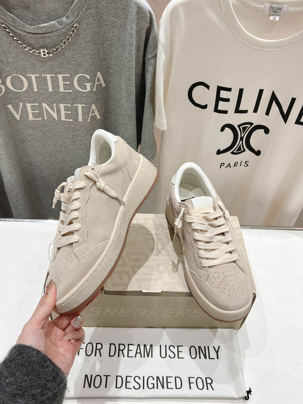 White low-top lace-up sneakers, side view pair on shoebox