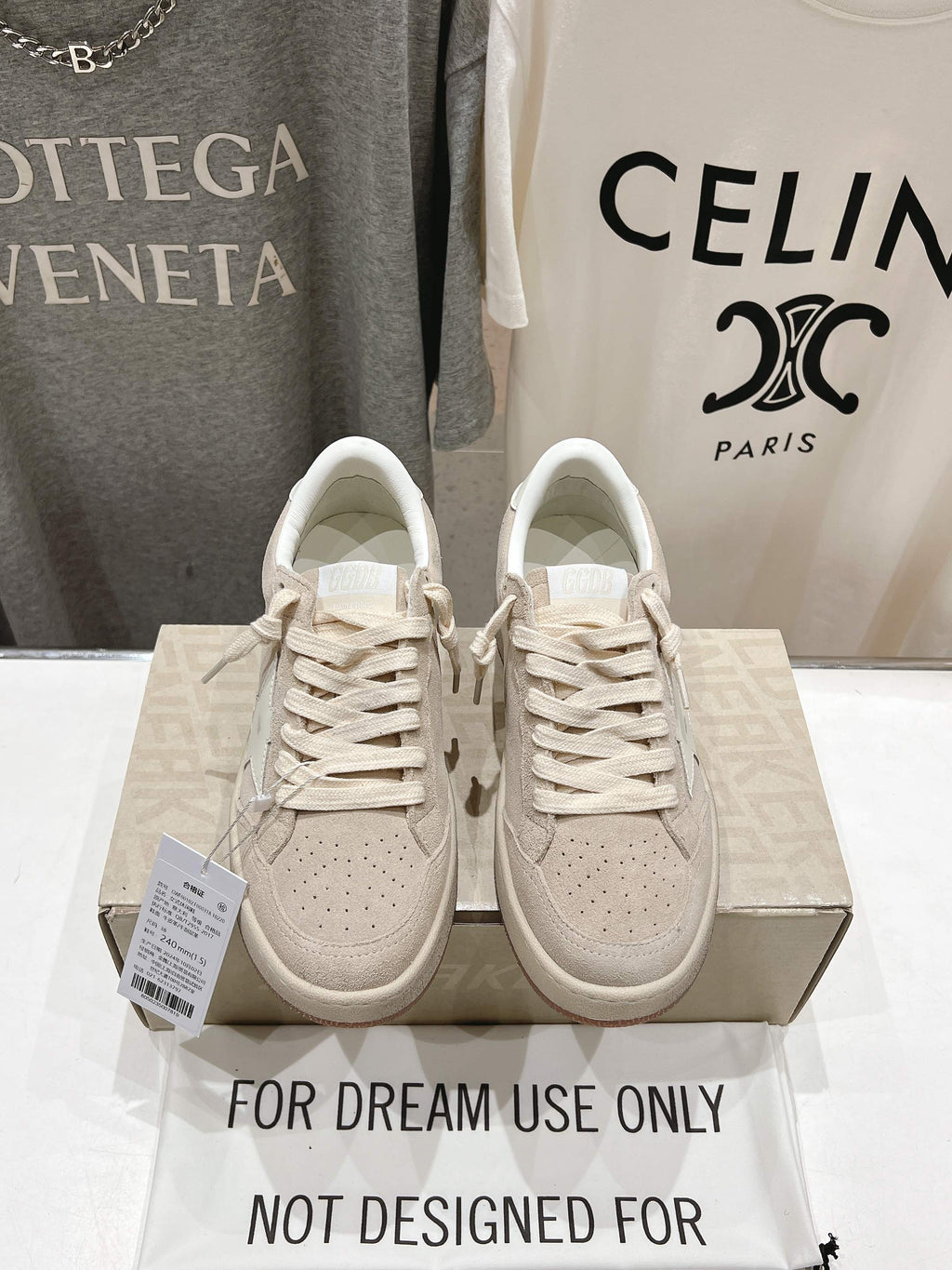 White lace-up sneakers, pair on shoebox with perforated toe details