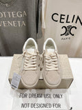 White lace-up sneakers, pair on shoebox with perforated toe details