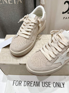 White lace-up sneakers, angled pair with side star detail on shoebox
