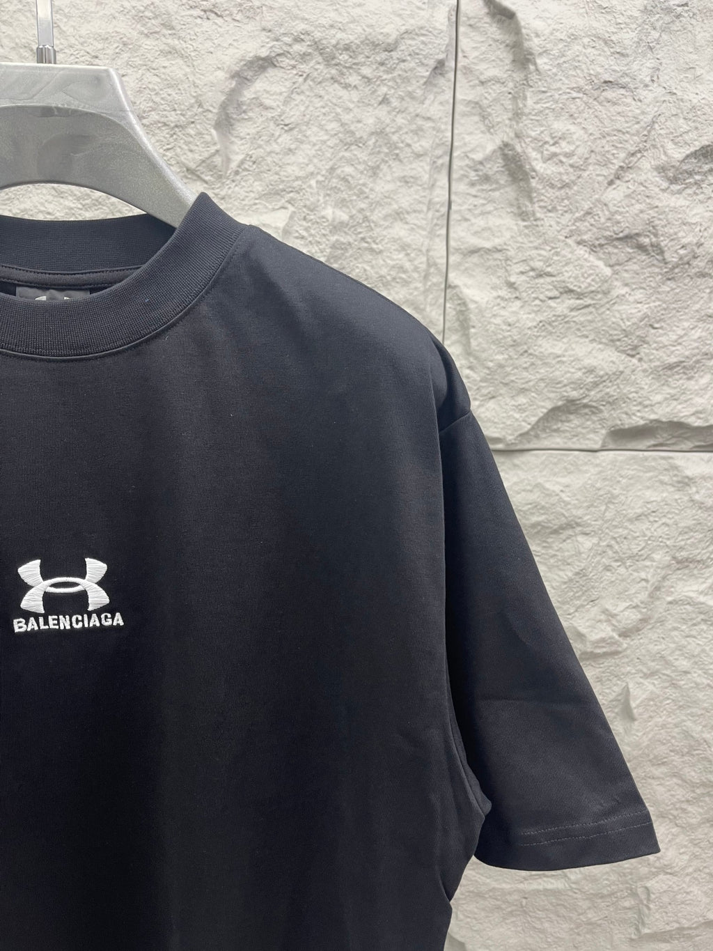 Dark navy short-sleeve T-shirt with chest logo and partial sleeve graphic