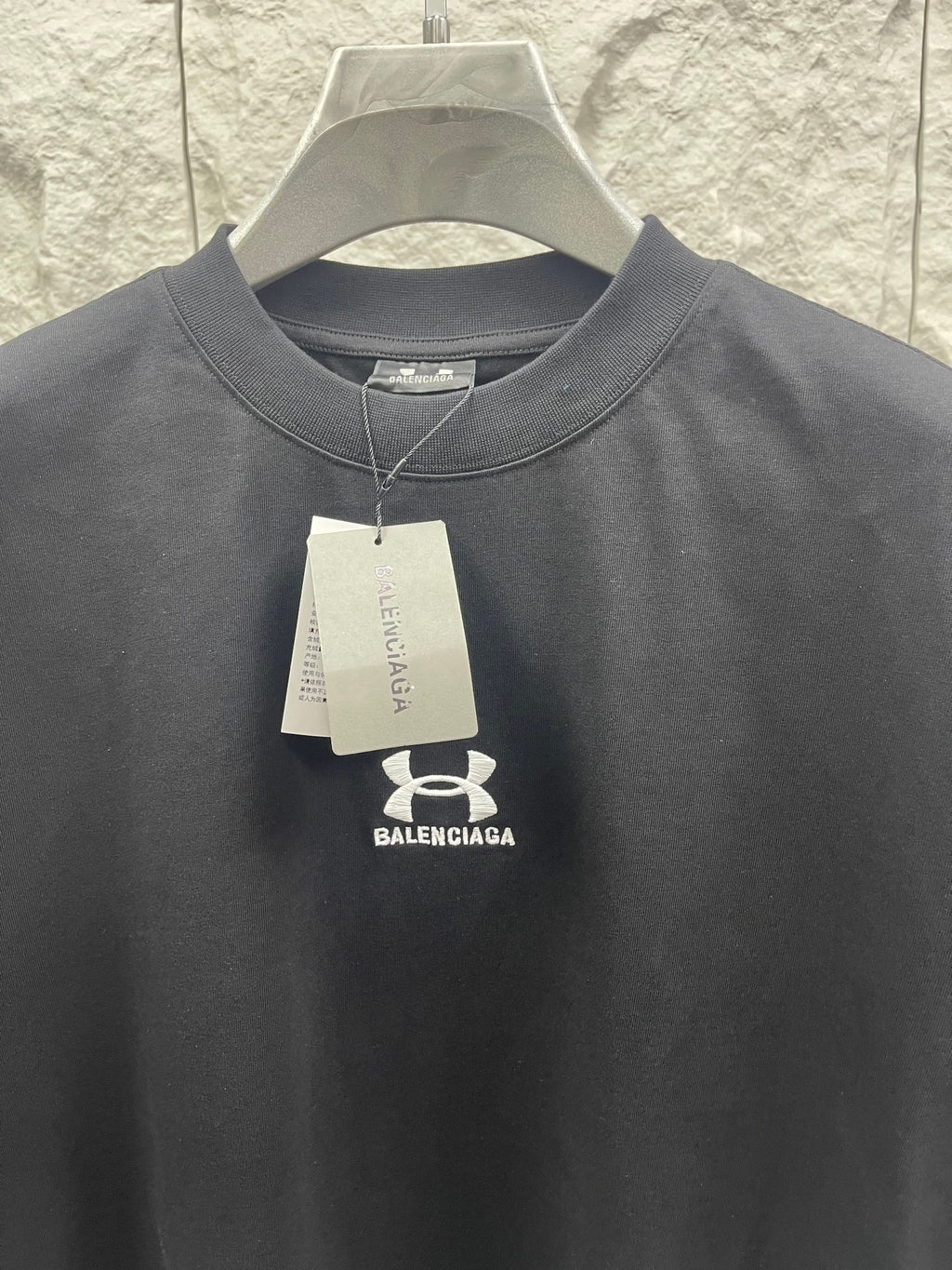 Gray crewneck T-shirt with hanging tag and small chest logo