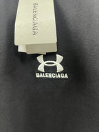 Dark navy T-shirt detail with white logo and hanging BALENCIAGA tag
