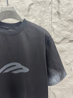 Dark graphic T-shirt detail with chest logo print