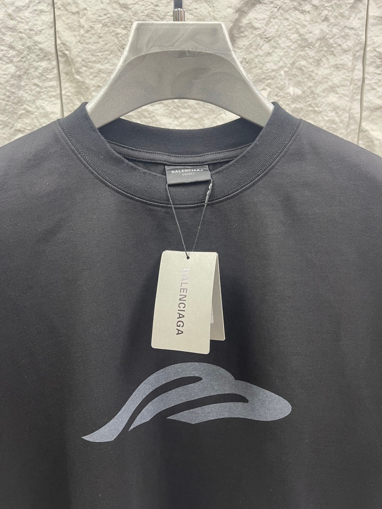 Dark graphic T-shirt close-up with hang tag and chest logo