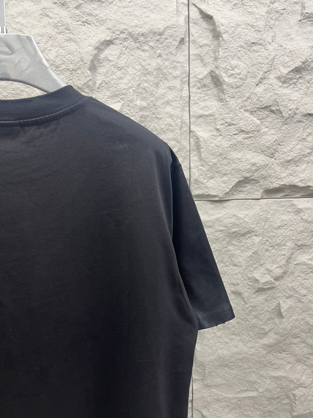 Dark T-shirt sleeve and shoulder view