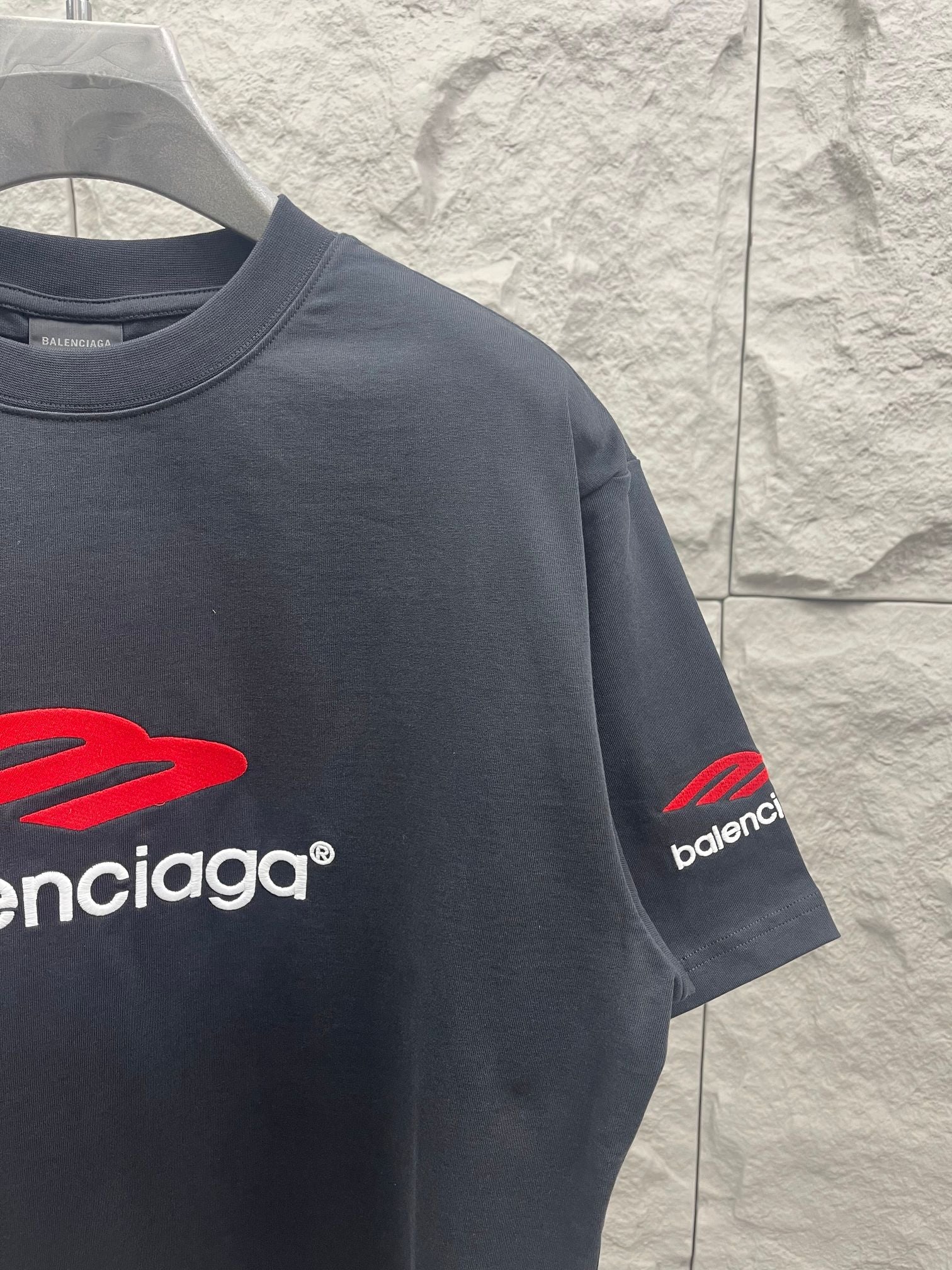 Balenciaga dark T-shirt with red Balenciaga logo on chest and sleeve