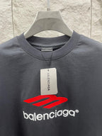 Balenciaga dark T-shirt with red logo graphic and Balenciaga tag at neckline