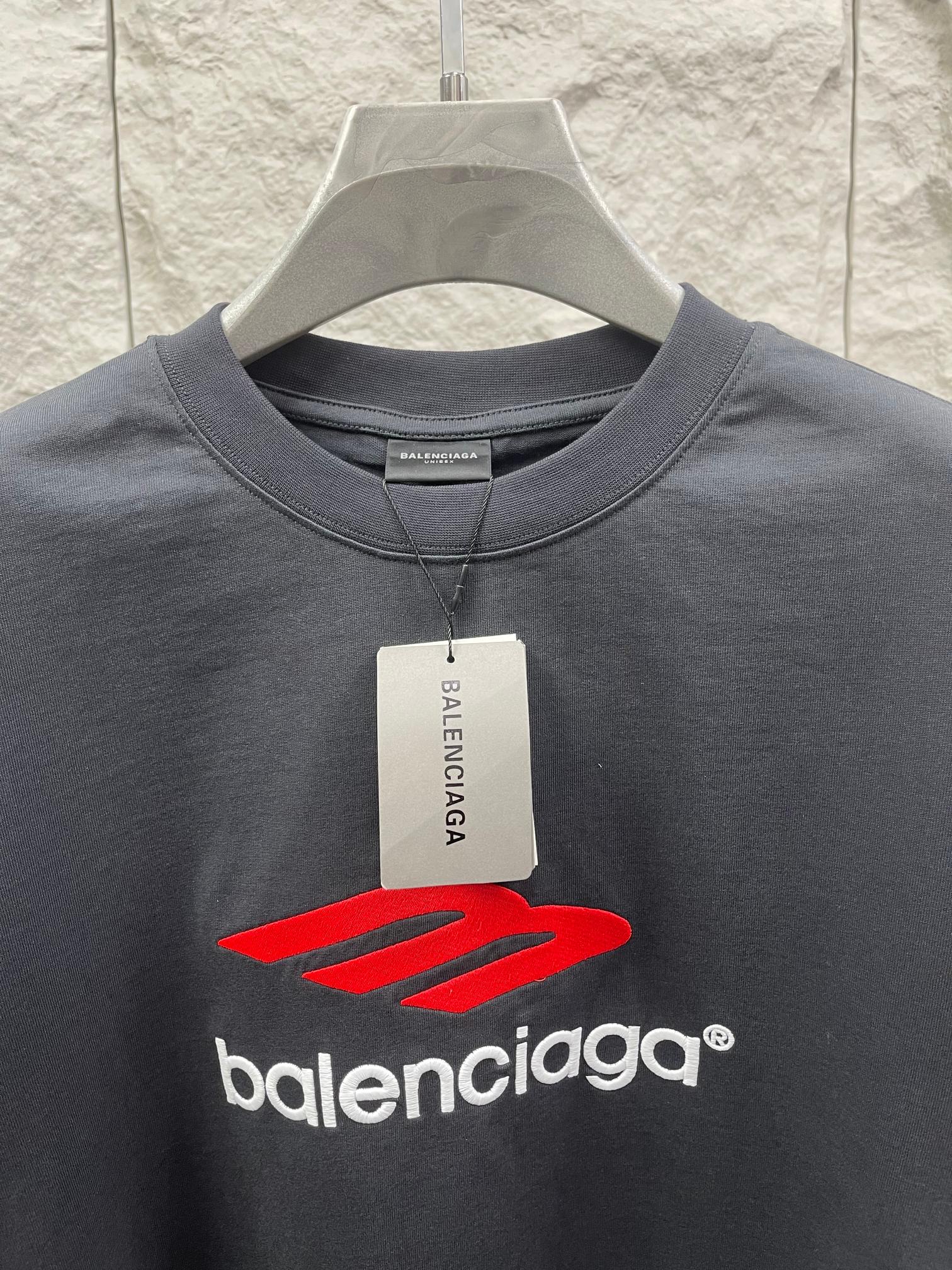 Balenciaga dark T-shirt with red logo graphic and Balenciaga tag at neckline
