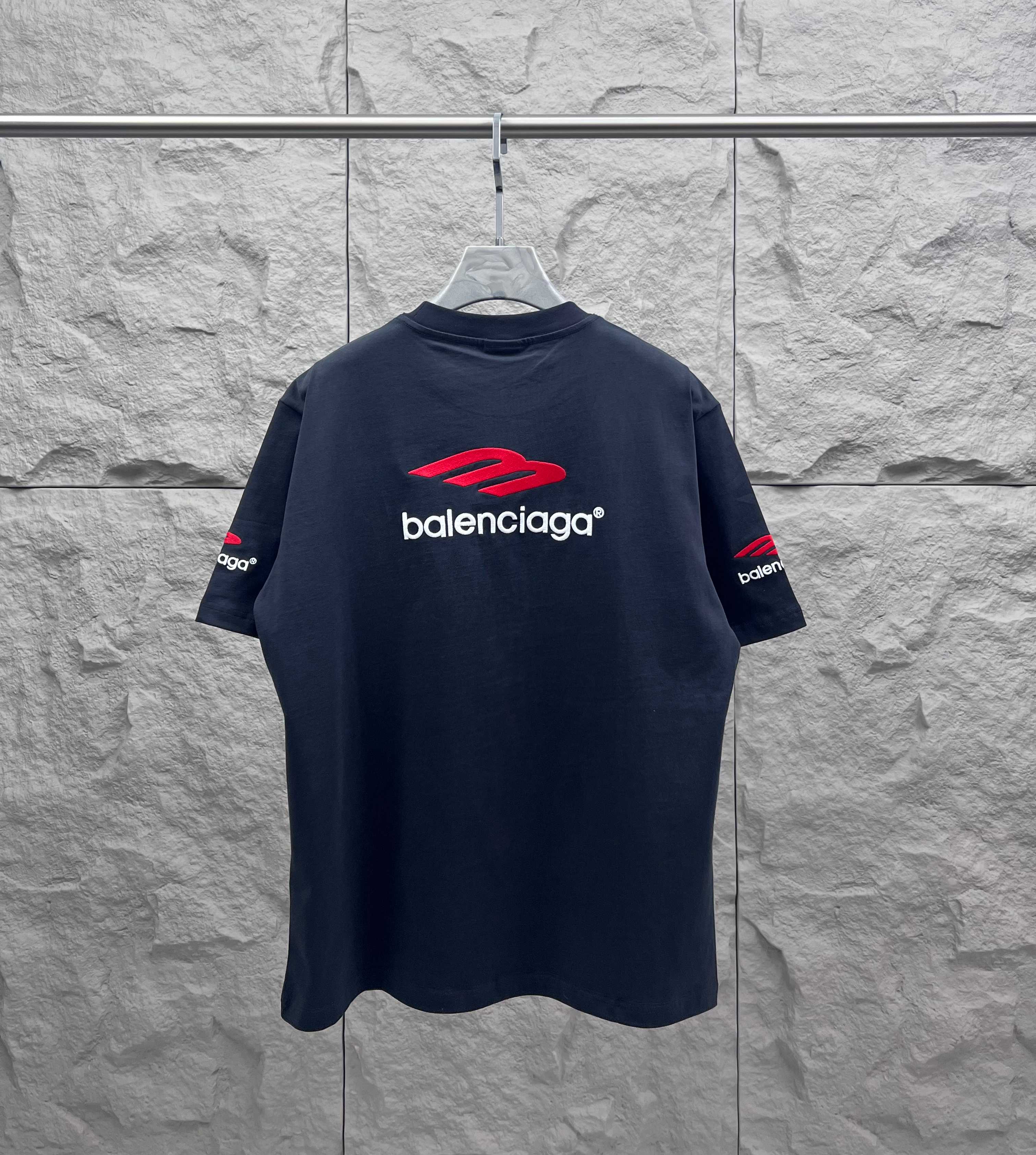 Balenciaga dark short-sleeve T-shirt, back view, red logo graphic and crew neck