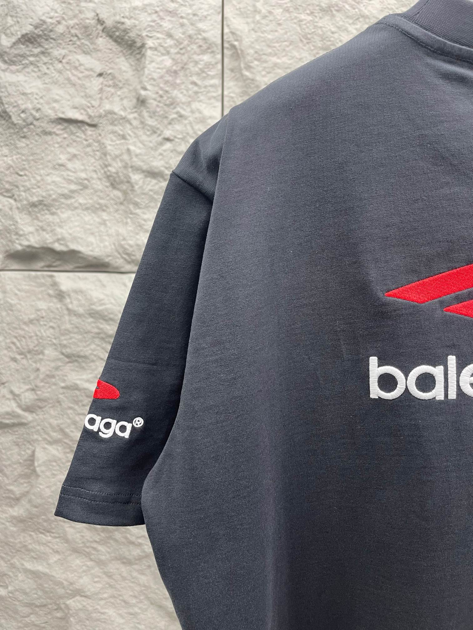 Balenciaga dark T-shirt with red logo and sleeve text detail