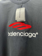 Balenciaga dark T-shirt with red Balenciaga logo, neckline tag visible