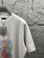 White T-shirt side view with partial Eiffel Tower print and Balenciaga hang tag