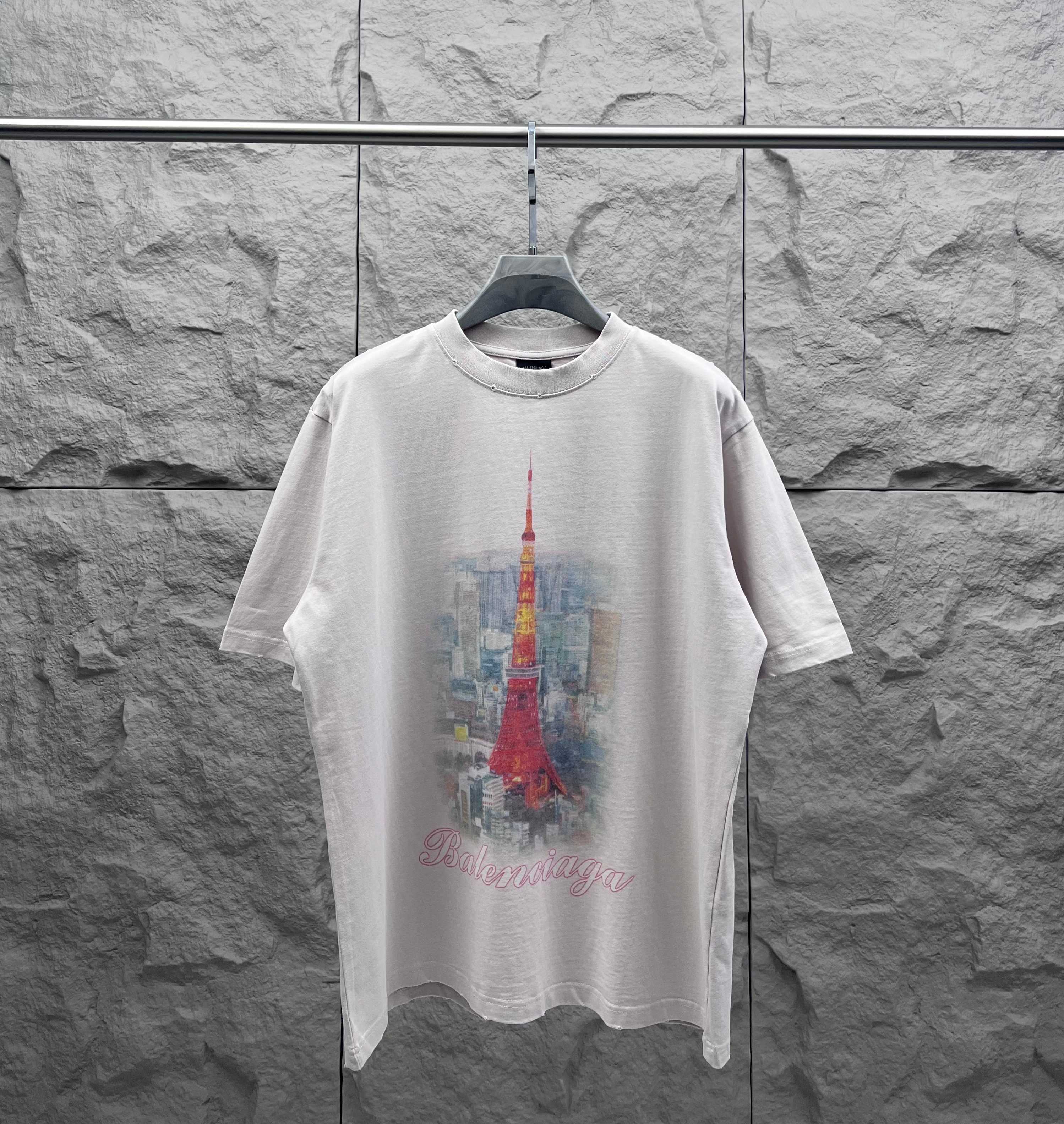 White short-sleeve T-shirt with red Eiffel Tower graphic and scripted logo