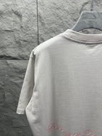 White T-shirt back neckline close-up with red script logo