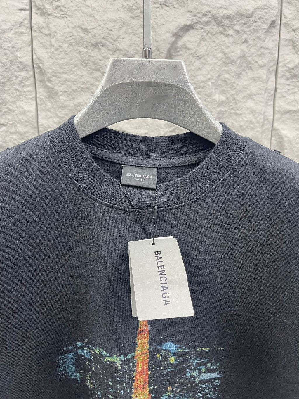 Dark gray short-sleeve T-shirt with crew neck, buttonless placket, and Eiffel Tower print
