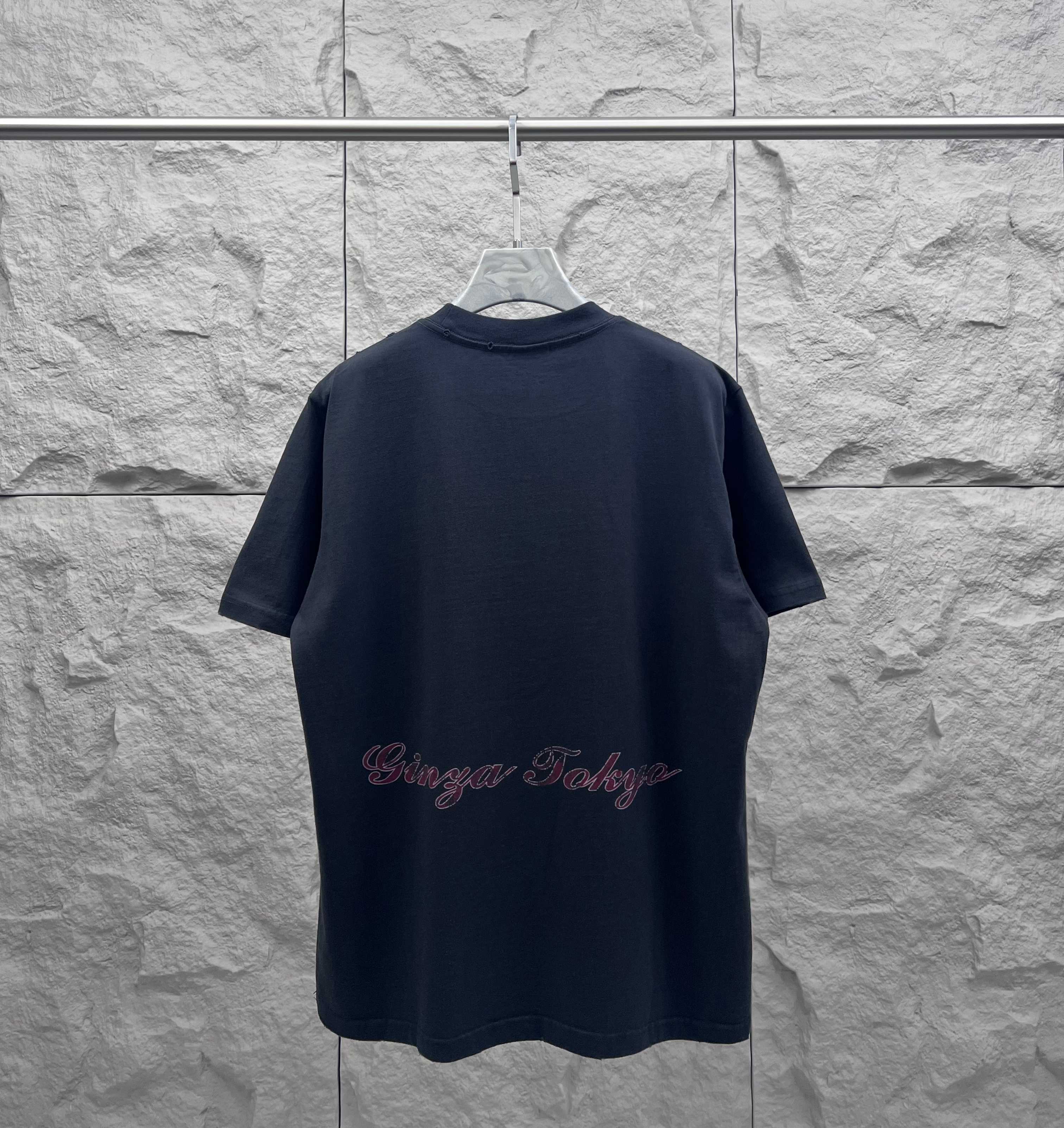 Navy short-sleeve T-shirt with Eiffel Tower graphic and cursive logo text on the back