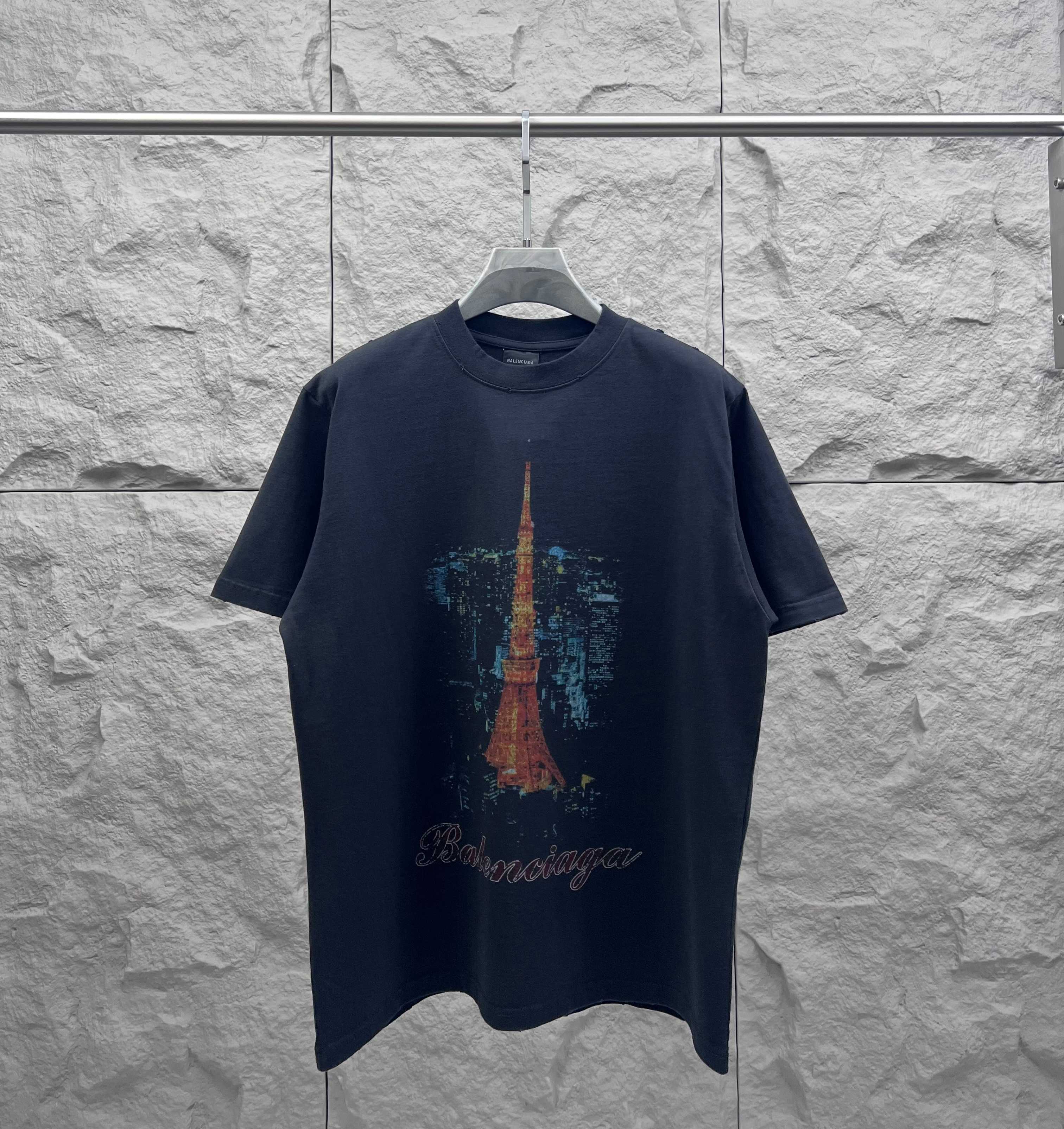 Navy short-sleeve T-shirt with Eiffel Tower graphic on the front and cursive logo text
