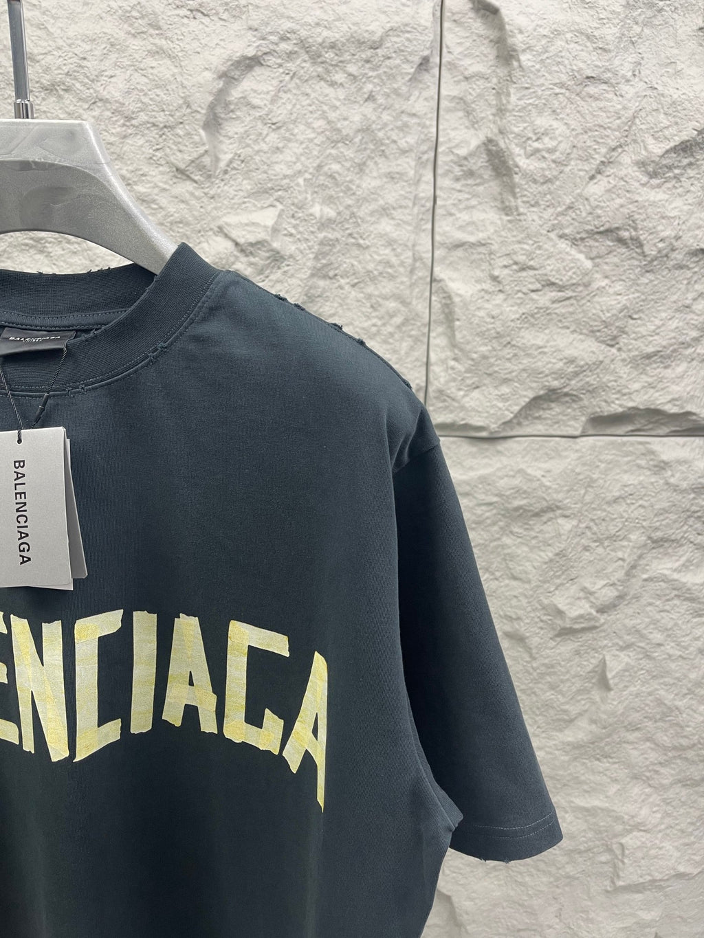 Balenciaga short-sleeve T-shirt, dark navy, side view with yellow BALENCIAGA graphic