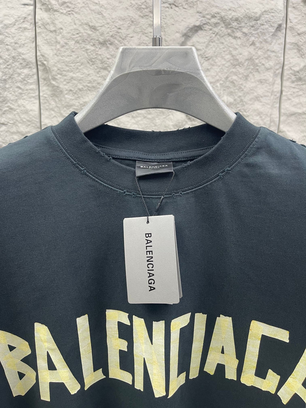 Balenciaga short-sleeve T-shirt neckline with size tag, dark navy, partial yellow logo