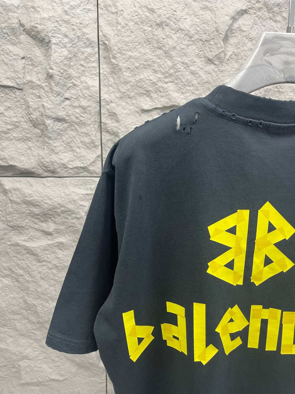Balenciaga short-sleeve T-shirt, dark navy, back view with yellow logo and stitched collar