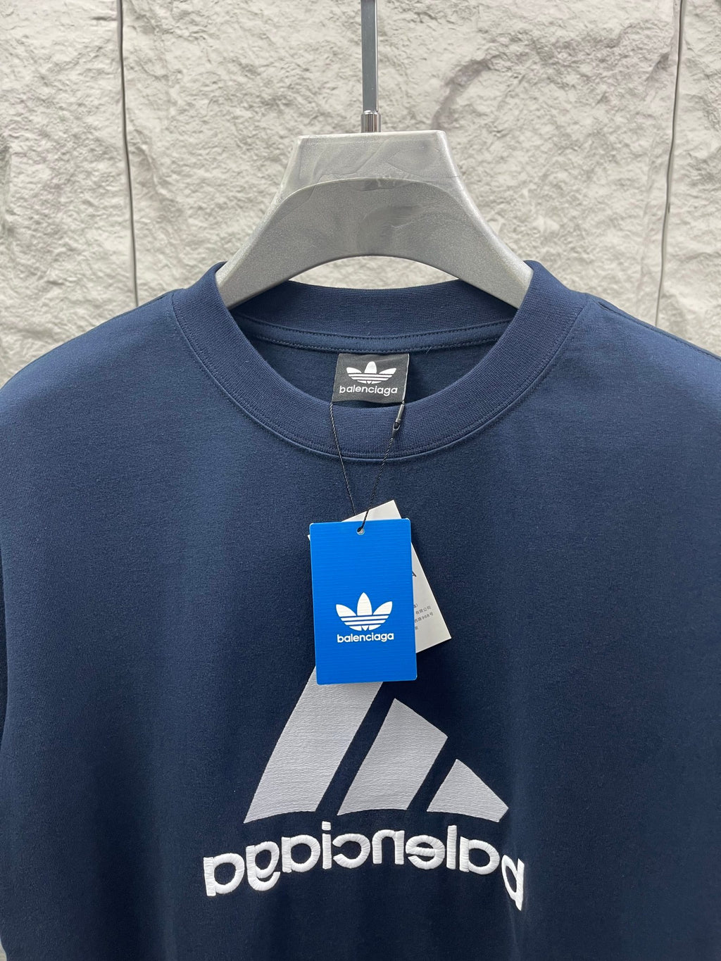 Balenciaga T-shirt close-up, navy blue, front logo and brand hang tag