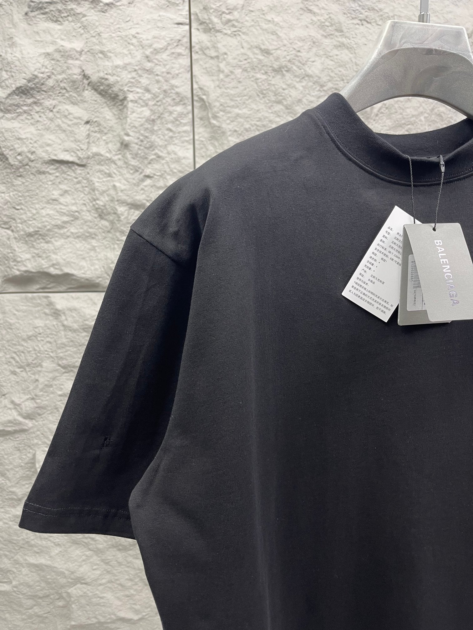 Balenciaga crewneck T-shirt with hang tag on collar, dark fabric