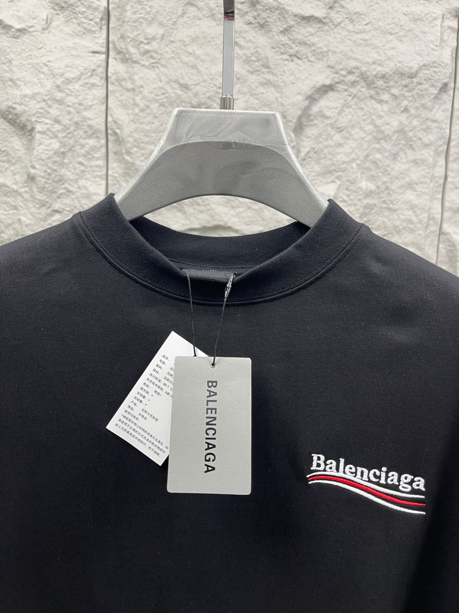 Balenciaga crewneck T-shirt in dark fabric with embroidered chest logo and hang tag