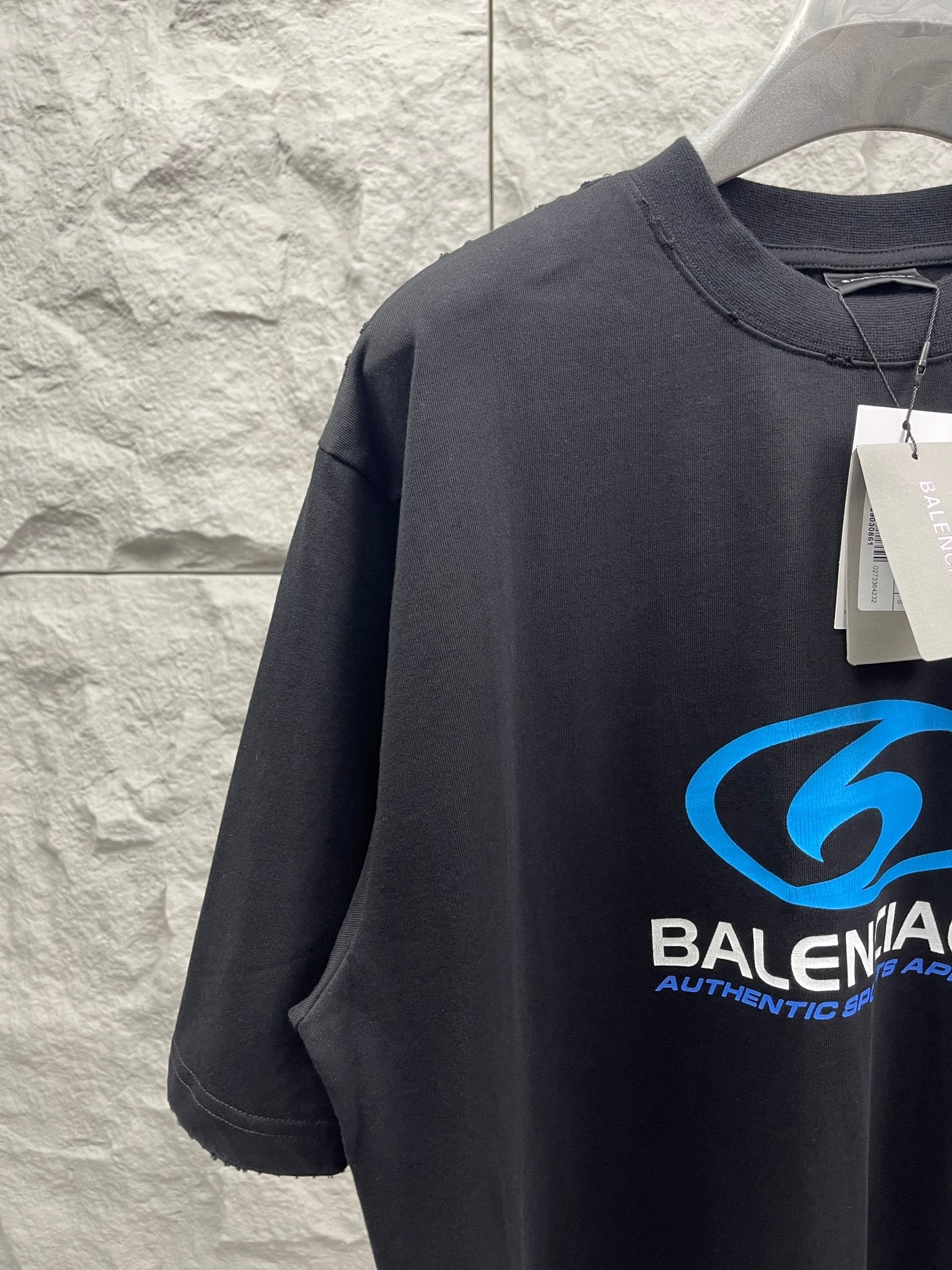 Balenciaga short-sleeve T-shirt, dark fabric with blue logo graphic on chest