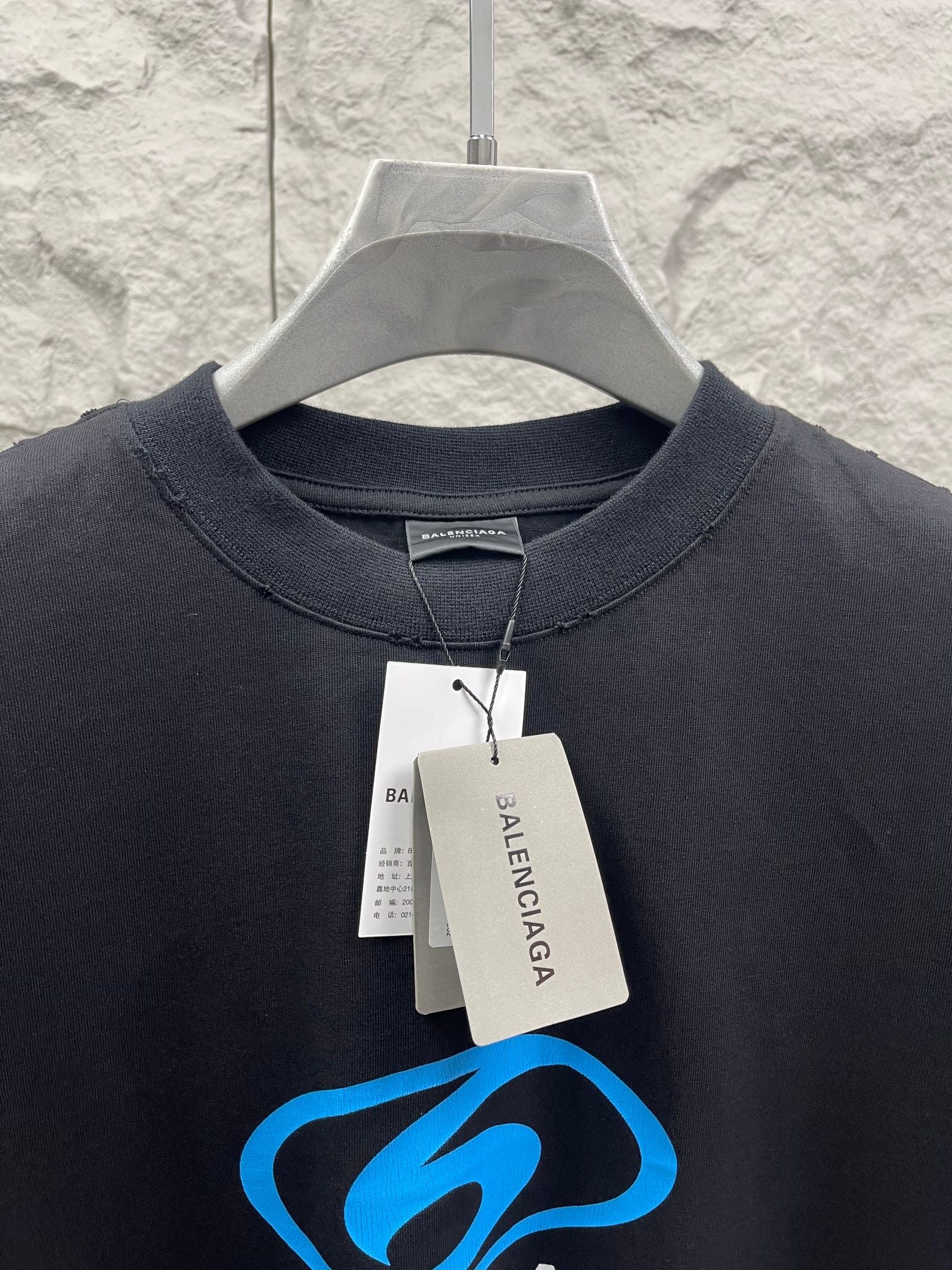 Balenciaga short-sleeve T-shirt neckline with hang tags and blue logo graphic
