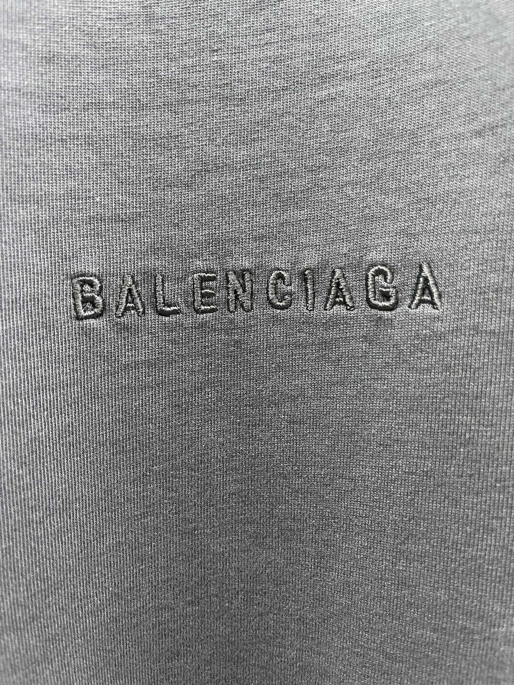 Balenciaga fabric close-up with embossed BALENCIAGA logo text