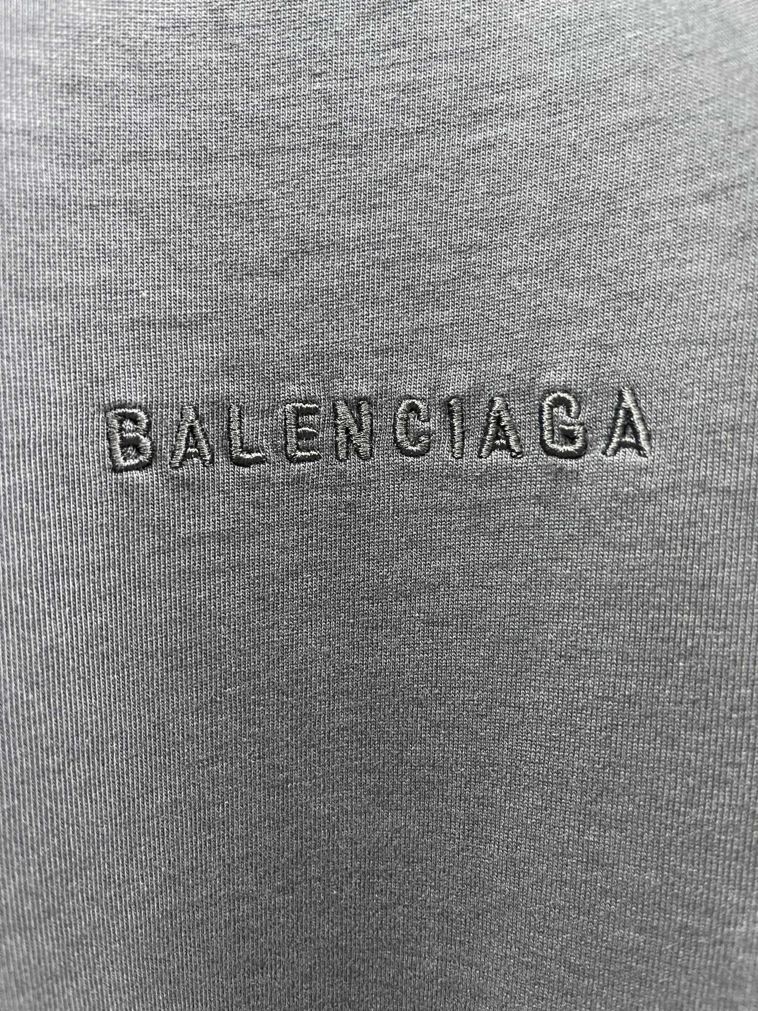 Balenciaga fabric close-up with embossed BALENCIAGA logo text