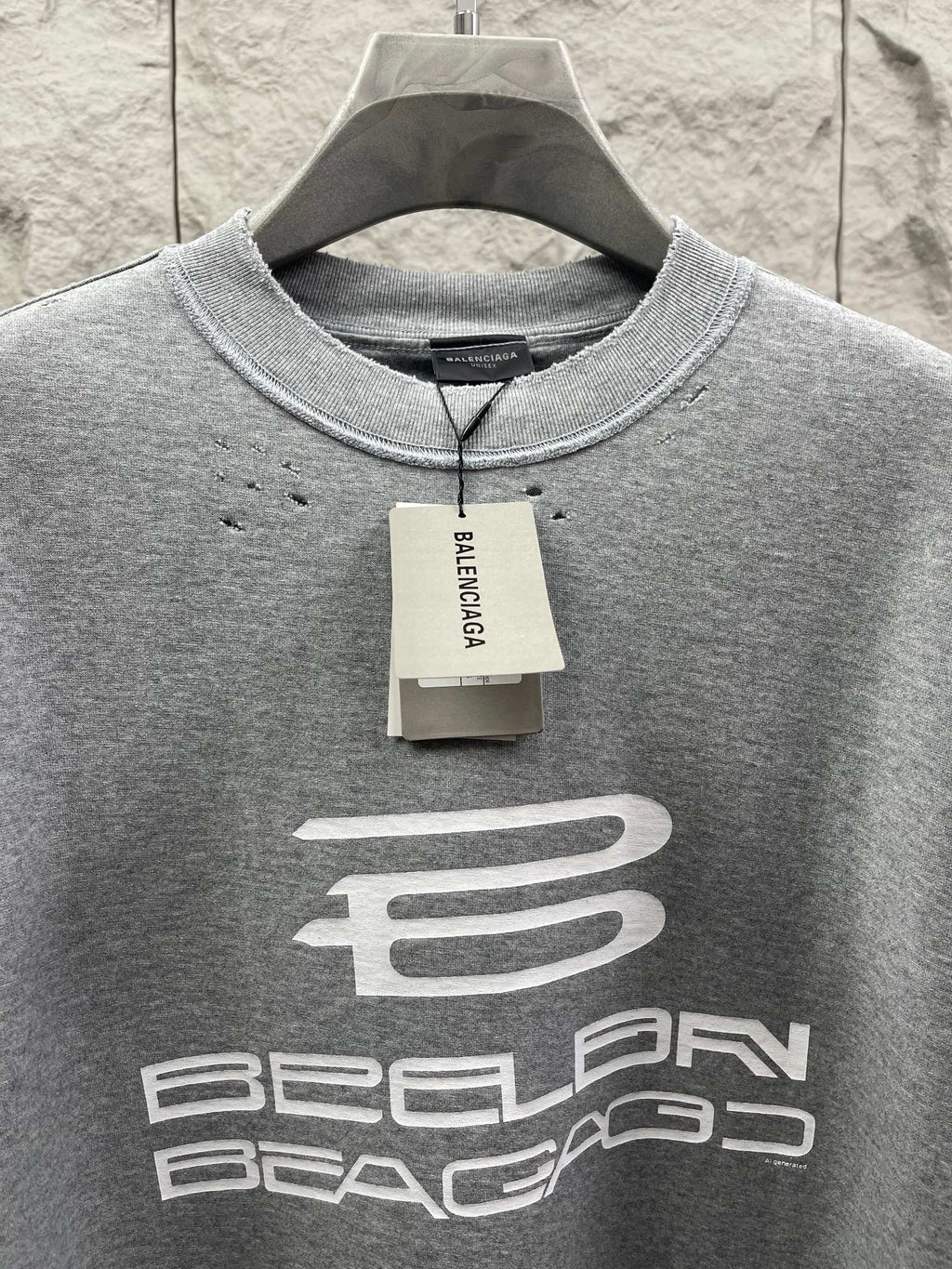 Grey T-shirt neckline with brand tag and large chest logo print.