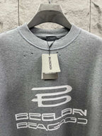 Grey T-shirt neckline with brand tag and large chest logo print.