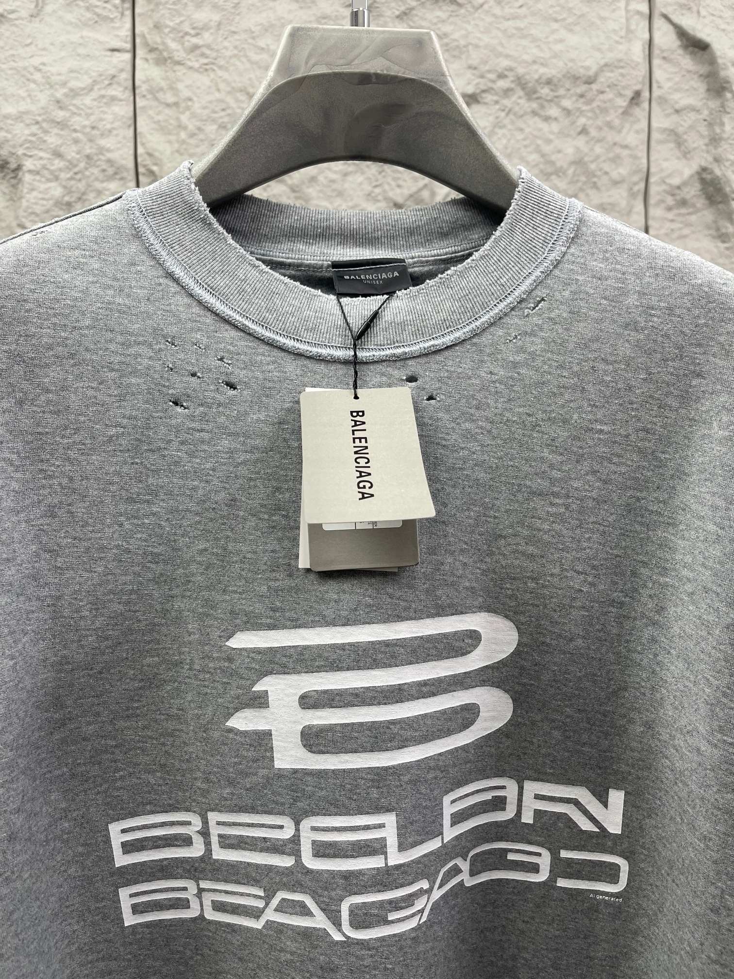Grey T-shirt neckline with brand tag and large chest logo print.