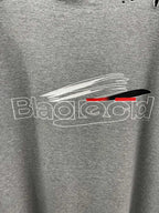 Grey T-shirt with close-up white and red logo graphic print.