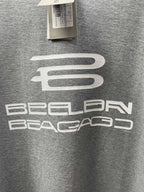 Grey T-shirt with centered white logo graphic detail.