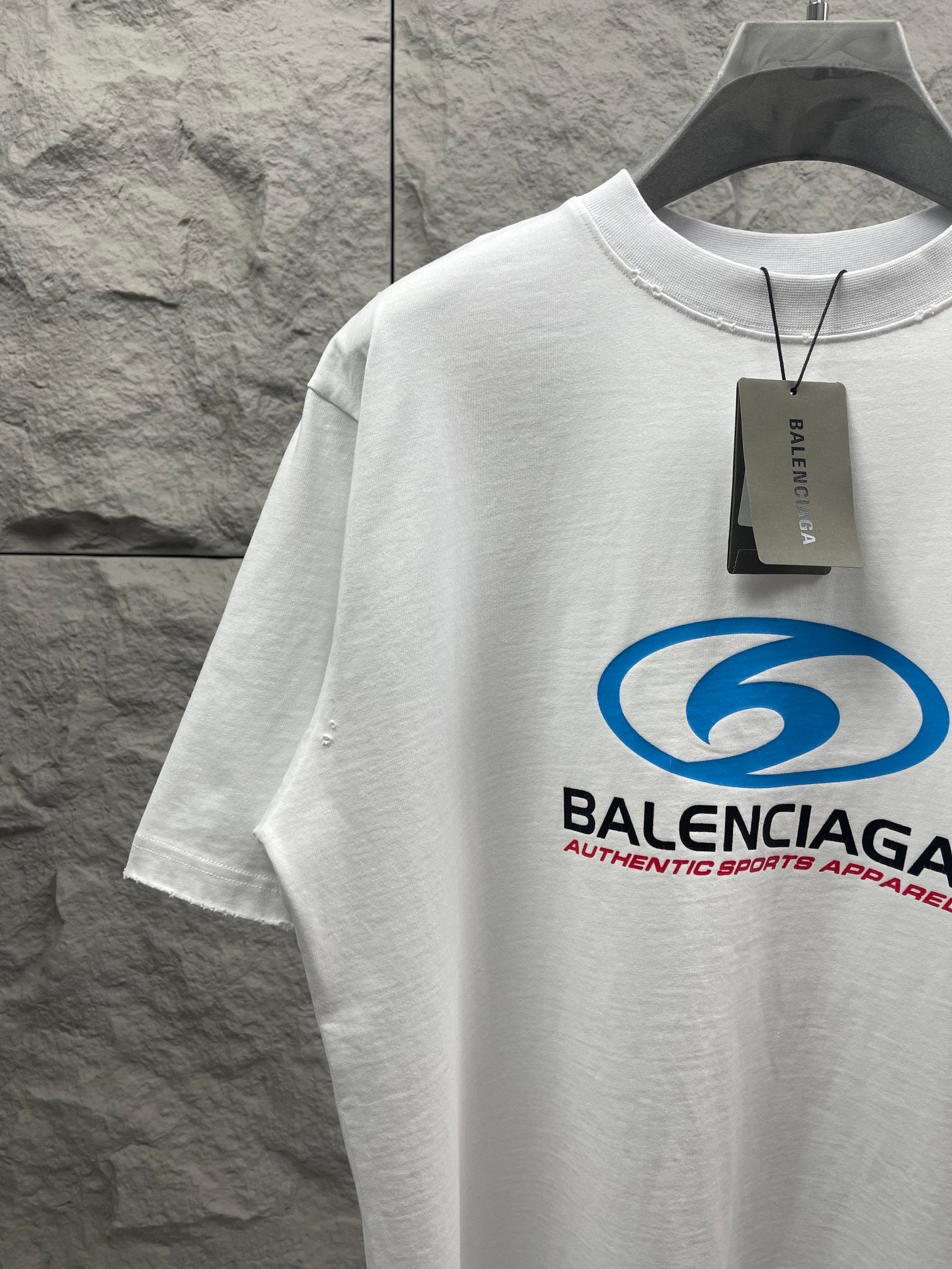 White short-sleeve T-shirt with blue Balenciaga logo and black size tag
